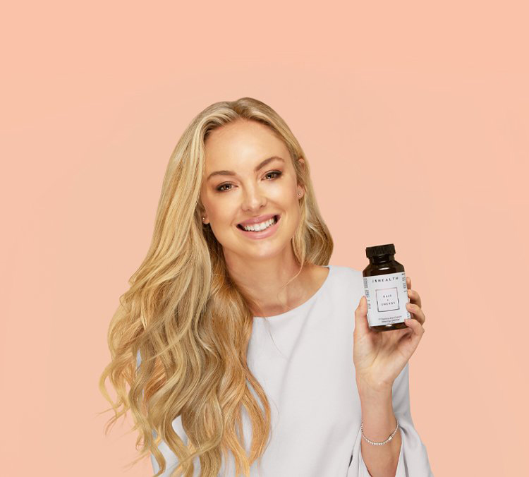 Jessica Sepel holding a JSHealth vitamin bottle