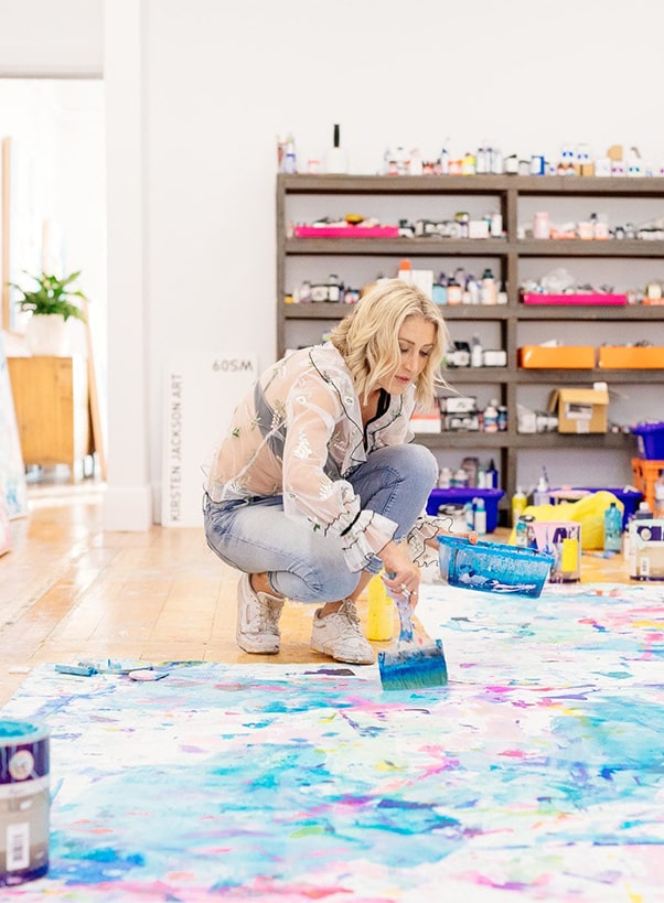 Kirsten Jackson painting in her colourful studio
